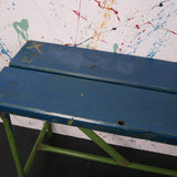 Children's wooden bench with blue top and metal frame